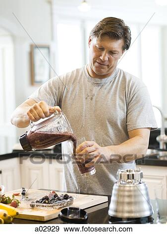 USA, Utah, Alpine, mature man pouring smoothie in kitchen View Large Photo Image Stock Photo - USA, Utah, Alpine, mature man pouring smoothie in kitchen. Fotosearch