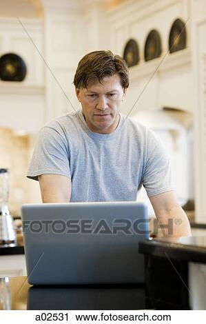 USA, Utah, Alpine, mature man standing and using laptop View Large Photo Image Stock Image - USA, Utah, Alpine, mature man standing and using laptop. Fotosearch