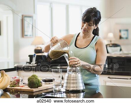 USA, Utah, Alpine, mid adult woman standing and pouring cocktail to glass View Large Photo Image Stock Image - USA, Utah, Alpine, mid adult woman standing and pouring cocktail to glass. Fotosearch
