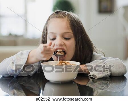 USA, Utah, Alpine, portrait of girl (8-9) eating breakfast View Large Photo Image Stock Image - USA, Utah, Alpine, portrait of girl (8-9) eating breakfast. Fotosearch