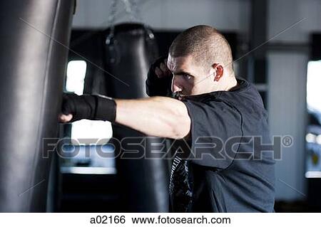 USA Utah, American Fork, Boxer punching boxing bag View Large Photo Image Stock Photograph - USA Utah, American Fork, Boxer punching boxing bag. Fotosearch