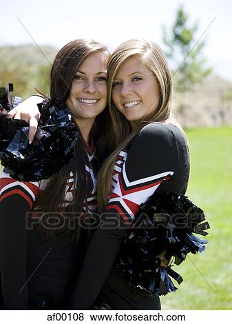 USA, Utah, American Fork, Portrait of two cheerleaders hugging View Large Photo Image Stock Photo - USA, Utah, American Fork, Portrait of two cheerleaders hugging. Fotosearch