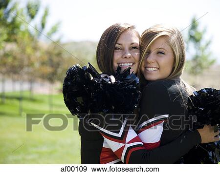 USA, Utah, American Fork, Portrait of two cheerleaders hugging View Large Photo Image Stock Photo - USA, Utah, American Fork, Portrait of two cheerleaders hugging. Fotosearch