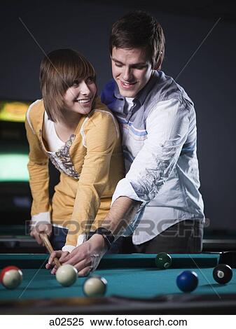USA, Utah, American Fork, young couple playing pool View Large Photo Image Stock Photography - USA, Utah, American Fork, young couple playing pool. Fotosearch