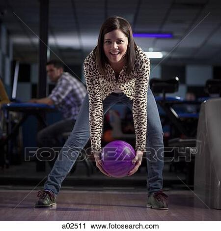 USA, Utah, American Fork, young woman holding bowling ball and smiling View Large Photo Image Stock Image - USA, Utah, American Fork, young woman holding bowling ball and smiling. Fotosearch
