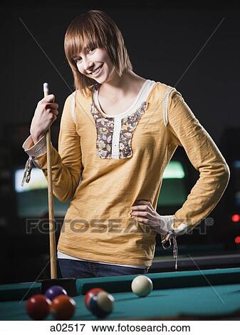 USA, Utah, American Fork, young woman standing behind pool table View Large Photo Image Stock Photo - USA, Utah, American Fork, young woman standing behind pool table. Fotosearch