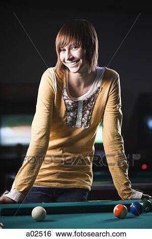 USA, Utah, American Fork, young woman standing behind pool table View Large Photo Image Stock Photograph - USA, Utah, American Fork, young woman standing behind pool table. Fotosearch