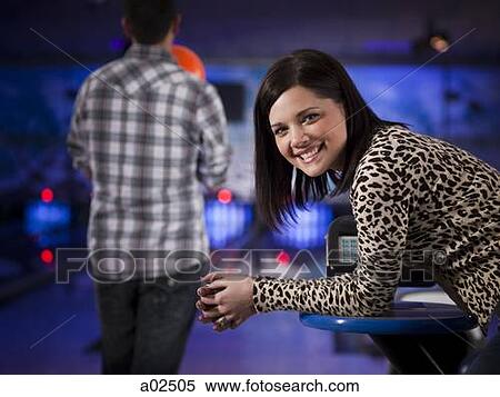 Stock Photography - USA, Utah, American Fork, young woman in a bowling club looking at camera. Fotosearch