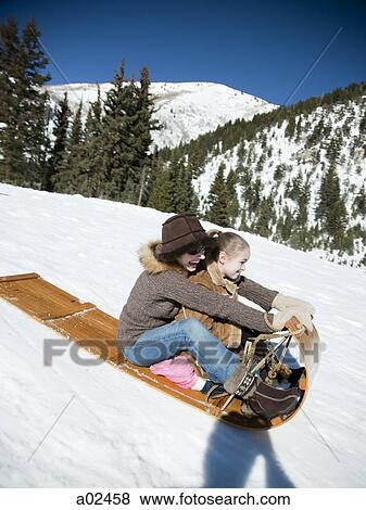 USA, Utah, Big Cottonwood Canyon, mother and daughter (8-9) tobogganing in mountains View Large Photo Image Stock Photo - USA, Utah, Big Cottonwood Canyon, mother and daughter (8-9) tobogganing in mountains. Fotosearch
