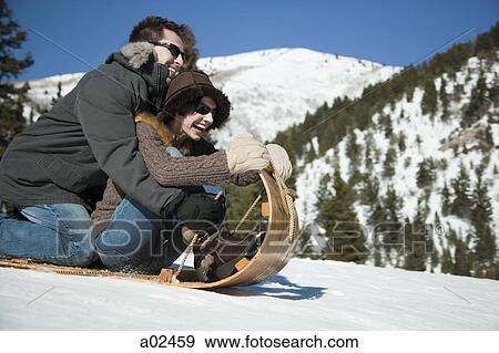 USA, Utah, Big Cottonwood Canyon, couple tobogganing in mountains View Large Photo Image Stock Photo - USA, Utah, Big Cottonwood Canyon, couple tobogganing in mountains. Fotosearch