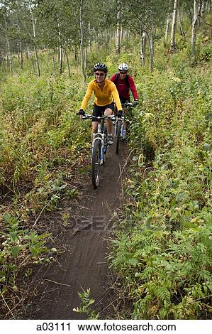 USA, Utah, couple mountain biking View Large Photo Image Stock Image - USA, Utah, couple mountain biking. Fotosearch