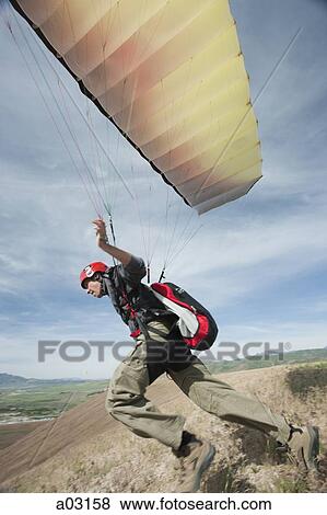 USA, Utah, Lehi, young paraglider starting from hill View Large Photo Image Stock Photo - USA, Utah, Lehi, young paraglider starting from hill. Fotosearch