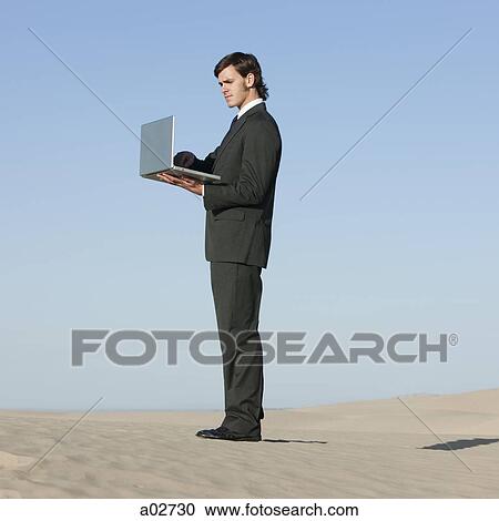USA, Utah, Little Sahara, businessman looking through telescope in desert View Large Photo Image Stock Image - USA, Utah, Little Sahara, businessman looking through telescope in desert. Fotosearch