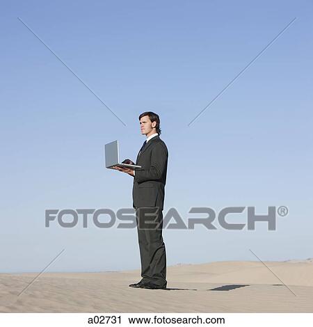 USA, Utah, Little Sahara, businessman looking through telescope in desert View Large Photo Image Stock Image - USA, Utah, Little Sahara, businessman looking through telescope in desert. Fotosearch
