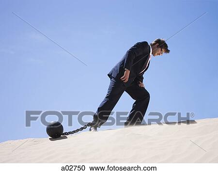 USA, Utah, Little Sahara, businessman wearing ball and chain in desert View Large Photo Image Stock Image - USA, Utah, Little Sahara, businessman wearing ball and chain in desert. Fotosearch