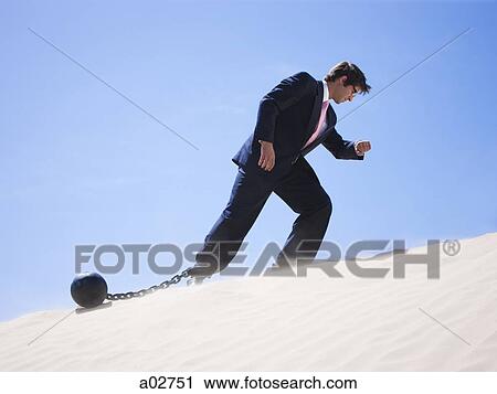 USA, Utah, Little Sahara, businessman wearing ball and chain in desert View Large Photo Image Stock Image - USA, Utah, Little Sahara, businessman wearing ball and chain in desert. Fotosearch