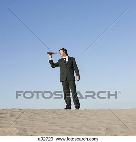 USA, Utah, Little Sahara, businessman looking through telescope in desert View Large Photo Image Stock Photo - USA, Utah, Little Sahara, businessman looking through telescope in desert. Fotosearch