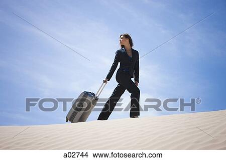 USA, Utah, Little Sahara, businesswoman pulling suitcase in desert View Large Photo Image Picture - USA, Utah, Little Sahara, businesswoman pulling suitcase in desert. Fotosearch