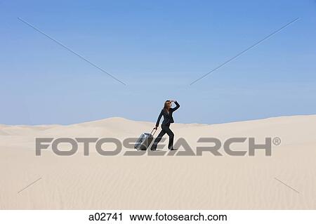 USA, Utah, Little Sahara, businesswoman pulling suitcase in desert View Large Photo Image Stock Image - USA, Utah, Little Sahara, businesswoman pulling suitcase in desert. Fotosearch
