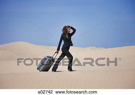 USA, Utah, Little Sahara, businesswoman pulling suitcase in desert View Large Photo Image Stock Image - USA, Utah, Little Sahara, businesswoman pulling suitcase in desert. Fotosearch