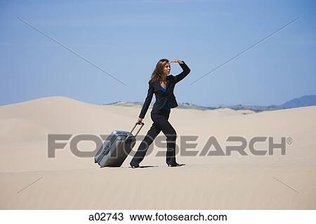 USA, Utah, Little Sahara, businesswoman pulling suitcase in desert View Large Photo Image Stock Image - USA, Utah, Little Sahara, businesswoman pulling suitcase in desert. Fotosearch