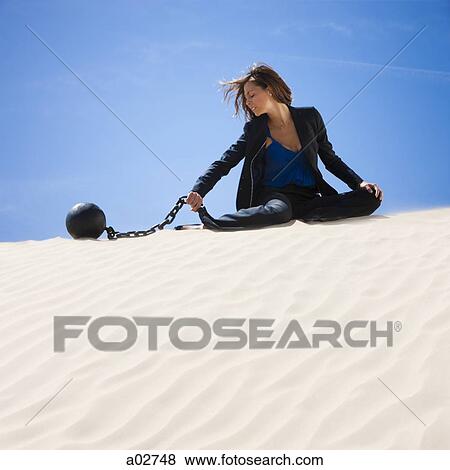 USA, Utah, Little Sahara, businesswoman wearing ball and chain in desert View Large Photo Image Stock Photo - USA, Utah, Little Sahara, businesswoman wearing ball and chain in desert. Fotosearch