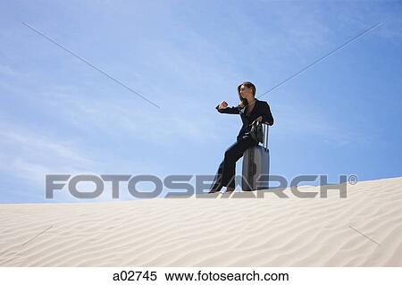 USA, Utah, Little Sahara, businesswoman sitting on suitcase in desert View Large Photo Image Stock Photography - USA, Utah, Little Sahara, businesswoman sitting on suitcase in desert. Fotosearch