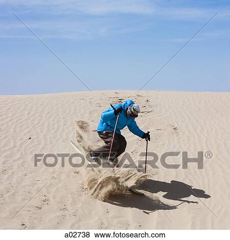 Stock Photo - USA, Utah, Little Sahara, man skiing in desert. Fotosearch
