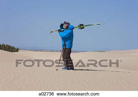 Stock Photograph - USA, Utah, Little Sahara, man with skiwear in desert. Fotosearch