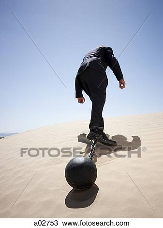 USA, Utah, Little Sahara, mid adult businessman pulling ball in chain on desert, rear view, low angle view View Large Photo Image Stock Image - USA, Utah, Little Sahara, mid adult businessman pulling ball in chain on desert, rear view, low angle view. Fotosearch