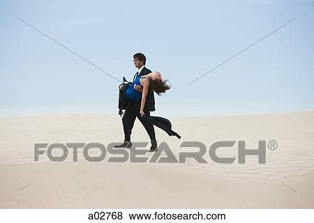 USA, Utah, Little Sahara, mid adult businessman carrying young woman on desert View Large Photo Image Stock Photo - USA, Utah, Little Sahara, mid adult businessman carrying young woman on desert. Fotosearch