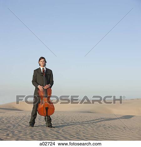 USA, Utah, Little Sahara, portrait of young man with cello in desert View Large Photo Image Picture - USA, Utah, Little Sahara, portrait of young man with cello in desert. Fotosearch