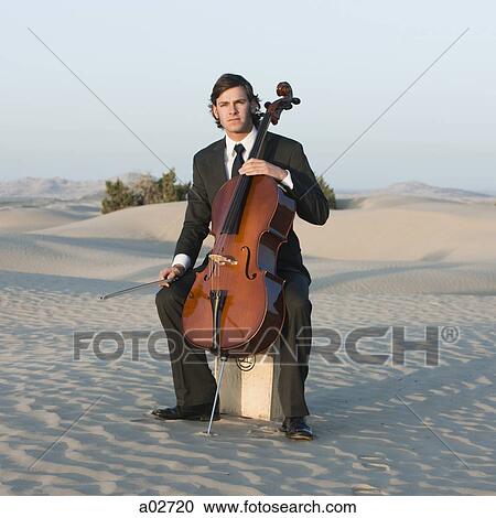 USA, Utah, Little Sahara, portrait of young man with cello in desert View Large Photo Image Stock Image - USA, Utah, Little Sahara, portrait of young man with cello in desert. Fotosearch