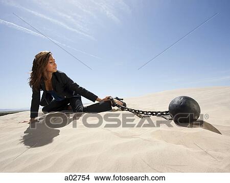 USA, Utah, Little Sahara, young businesswoman pulling ball in chain on desert View Large Photo Image Picture - USA, Utah, Little Sahara, young businesswoman pulling ball in chain on desert. Fotosearch