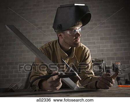 Stock Photograph - USA, Utah, Orem, male welder in workshop. Fotosearch