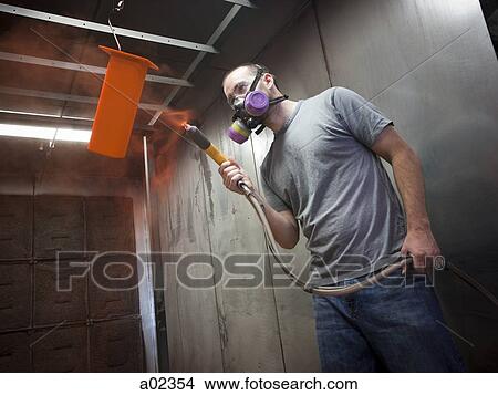USA, Utah, Orem, man using paint spray gun View Large Photo Image Picture - USA, Utah, Orem, man using paint spray gun. Fotosearch