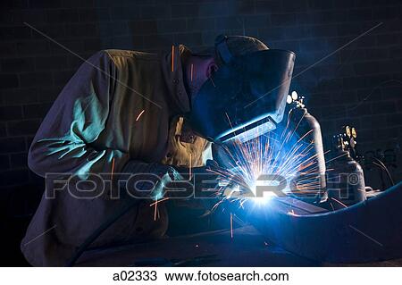 USA, Utah, Orem, man welding metal in workshop View Large Photo Image Stock Image - USA, Utah, Orem, man welding metal in workshop. Fotosearch