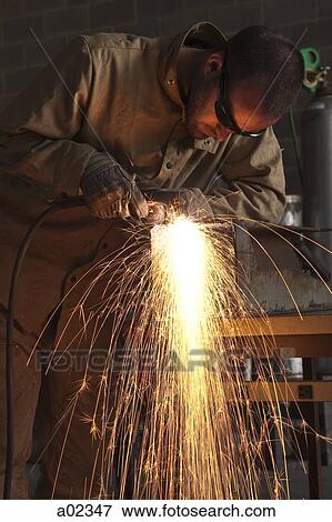 USA, Utah, Orem, man welding metal in workshop View Large Photo Image Stock Photo - USA, Utah, Orem, man welding metal in workshop. Fotosearch