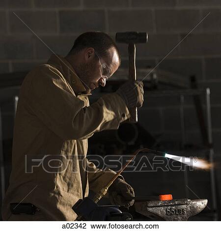 USA, Utah, Orem, man welding with hammer and blowtorch in workshop View Large Photo Image Stock Image - USA, Utah, Orem, man welding with hammer and blowtorch in workshop. Fotosearch