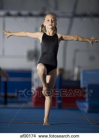 Picture - USA, Utah, Orem, portrait of girl (8-9) exercising in gym. Fotosearch
