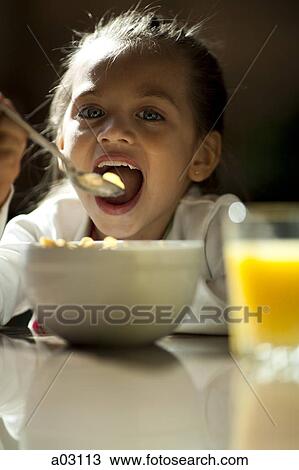 USA, Utah, Orem, portrait of girl (8-9) eating View Large Photo Image Stock Image - USA, Utah, Orem, portrait of girl (8-9) eating. Fotosearch