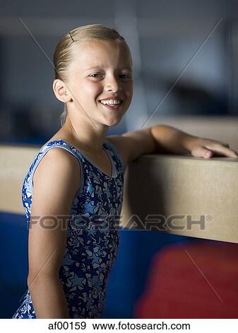 USA, Utah, Orem, portrait of girl (10-11) leaning on balance beam in gym View Large Photo Image Stock Photo - USA, Utah, Orem, portrait of girl (10-11) leaning on balance beam in gym. Fotosearch