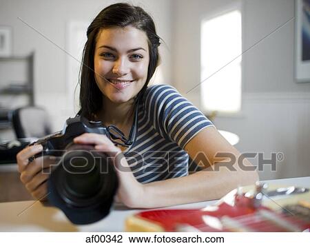USA, Utah, Orem, Portrait of teenage girl (16-17) holding camera View Large Photo Image Stock Image - USA, Utah, Orem, Portrait of teenage girl (16-17) holding camera. Fotosearch