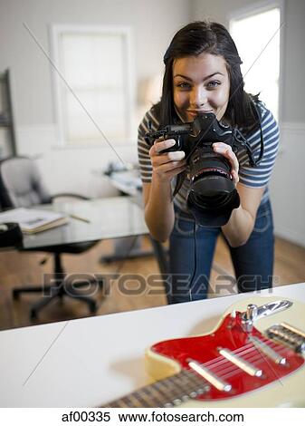 USA, Utah, Orem, Portrait of teenage girl (16-17) photographing guitar View Large Photo Image Stock Photography - USA, Utah, Orem, Portrait of teenage girl (16-17) photographing guitar. Fotosearch