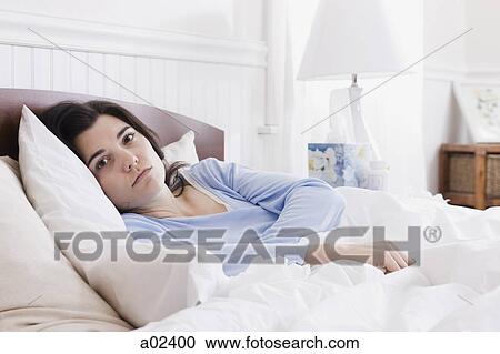 USA, Utah, Orem, portrait of young woman lying in bed View Large Photo Image Stock Image - USA, Utah, Orem, portrait of young woman lying in bed. Fotosearch