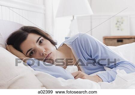 USA, Utah, Orem, portrait of young woman lying in bed View Large Photo Image Stock Photo - USA, Utah, Orem, portrait of young woman lying in bed. Fotosearch