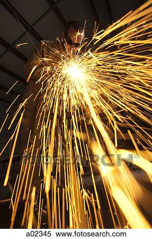 USA, Utah, Orem, sparks from man welding metal View Large Photo Image Stock Photography - USA, Utah, Orem, sparks from man welding metal. Fotosearch