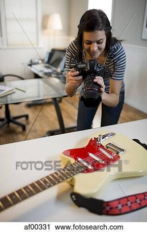 USA, Utah, Orem, Teenage girl (16-17) photographing guitar View Large Photo Image Stock Image - USA, Utah, Orem, Teenage girl (16-17) photographing guitar. Fotosearch