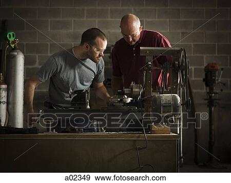 USA, Utah, Orem, two men working in workshop View Large Photo Image Stock Photo - USA, Utah, Orem, two men working in workshop. Fotosearch