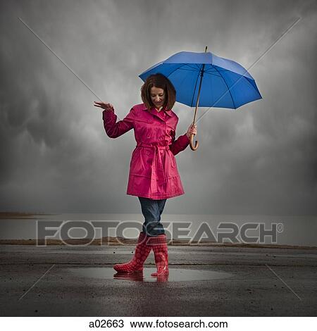 USA, Utah, Orem, woman with umbrella standing in puddle View Large Photo Image Stock Image - USA, Utah, Orem, woman with umbrella standing in puddle. Fotosearch